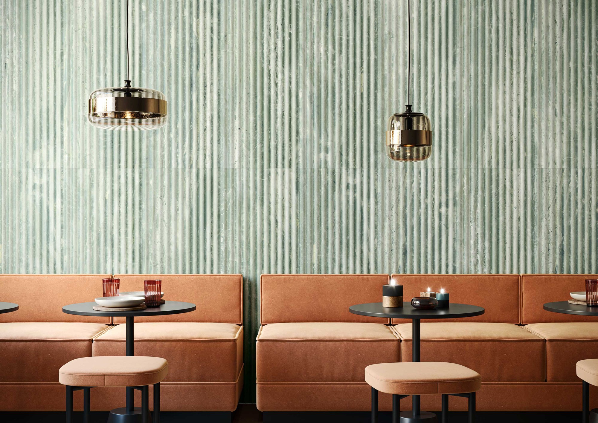 Fluted Travertino Jungle tiles in a restaurant interior with green relief walls and terracotta seating
